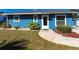 Charming single-story home with light blue siding, a well-maintained lawn, and fresh landscaping at 3249 Cedarbrook Dr, Punta Gorda, FL 33982