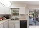 Well-lit kitchen boasts a stainless steel sink, appliances and a sliding glass door leading to the patio at 3249 Cedarbrook Dr, Punta Gorda, FL 33982
