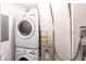 A stacked washer and dryer setup sit next to a heater/AC unit at 3249 Cedarbrook Dr, Punta Gorda, FL 33982