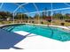 An outdoor pool is showcased within a screened enclosure, surrounded by greenery at 3249 Cedarbrook Dr, Punta Gorda, FL 33982