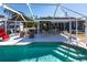 The pool features a screened enclosure with outdoor seating and landscaping at 3249 Cedarbrook Dr, Punta Gorda, FL 33982