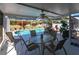 A screened porch includes an outdoor dining area with view of the pool at 3249 Cedarbrook Dr, Punta Gorda, FL 33982