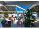 A screened lanai with comfortable seating offers views of the pool and backyard at 3249 Cedarbrook Dr, Punta Gorda, FL 33982