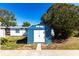 Exterior view of a blue and white storage shed with double doors at 3249 Cedarbrook Dr, Punta Gorda, FL 33982