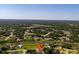Expansive aerial view of home with lush green surroundings and a nearby canal, offering serene waterfront living at 3476 Brewster Rd, North Port, FL 34288