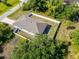 Birds eye view shows a large lot, fenced yard, and fire pit area at 3476 Brewster Rd, North Port, FL 34288