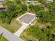 Lovely aerial shot of the home and a green backyard with a fire pit and lush landscaping at 3476 Brewster Rd, North Port, FL 34288
