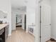 Bathroom leading to bedroom, features a tub and granite countertop with a large open space at 3476 Brewster Rd, North Port, FL 34288