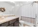 Bathroom features granite countertop, single sink, updated fixtures, shower/tub with white curtain at 3476 Brewster Rd, North Port, FL 34288