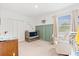 Cozy bedroom with crib, rocking chair and closet at 3476 Brewster Rd, North Port, FL 34288