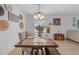 Bright dining area features a long table with seating for six, decor, and adjacent living room at 3476 Brewster Rd, North Port, FL 34288