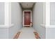 Inviting front entrance featuring a decorative red door with stylish wreath and stone walkway at 3476 Brewster Rd, North Port, FL 34288