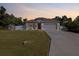 Charming single-story home boasts a well-manicured lawn, two car garage, and inviting curb appeal at 3476 Brewster Rd, North Port, FL 34288