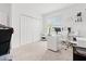 Bright home office with a large window, white desk, and closet at 3476 Brewster Rd, North Port, FL 34288
