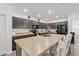 Spacious kitchen features dark wood cabinets, stainless appliances, and large island with barstool seating at 3476 Brewster Rd, North Port, FL 34288