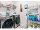 A convenient laundry room features modern washer and dryer, shelving, and storage space at 3476 Brewster Rd, North Port, FL 34288