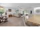 Bright, open-concept living area features a large sofa, sliding doors, and seamless flow from the kitchen at 3476 Brewster Rd, North Port, FL 34288