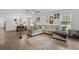 Open-concept living area featuring plush seating and view to dining area at 3476 Brewster Rd, North Port, FL 34288