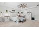Bright main bedroom featuring white furniture and a decorative ceiling fan at 3476 Brewster Rd, North Port, FL 34288