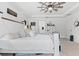 Light filled main bedroom showcasing elegant furniture and tray ceilings at 3476 Brewster Rd, North Port, FL 34288