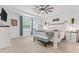 Serene main bedroom with tray ceiling, ceiling fan, and ample light at 3476 Brewster Rd, North Port, FL 34288