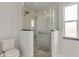 Bathroom featuring a glass-enclosed shower and modern toilet at 3480 Pinetree St, Port Charlotte, FL 33952