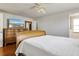 Bright bedroom with wood floors, dresser, TV and ceiling fan at 3480 Pinetree St, Port Charlotte, FL 33952