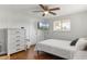 Bright bedroom with wood floors, dresser, TV and ceiling fan at 3480 Pinetree St, Port Charlotte, FL 33952