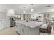 Bright, open kitchen featuring a large island with white cabinets and modern appliances at 3480 Pinetree St, Port Charlotte, FL 33952