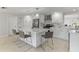 Stylish kitchen with white cabinets, a central island, and modern pendant lighting at 3480 Pinetree St, Port Charlotte, FL 33952