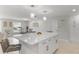 Bright, open kitchen with an island, modern fixtures, and access to the dining area at 3480 Pinetree St, Port Charlotte, FL 33952