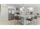 Modern kitchen featuring white cabinetry, a large island, and stainless steel appliances at 3480 Pinetree St, Port Charlotte, FL 33952