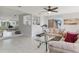 Bright living room featuring tile flooring, neutral furniture, and an open layout at 3480 Pinetree St, Port Charlotte, FL 33952