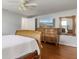 Main bedroom features wood floors, large dresser and view to TV at 3480 Pinetree St, Port Charlotte, FL 33952