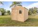Outdoor storage shed in backyard featuring a door and window at 3480 Pinetree St, Port Charlotte, FL 33952