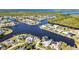 Stunning aerial view of a waterfront community with deep water canal access and beautiful landscaping at 4178 Rose Arbor Cir, Port Charlotte, FL 33948