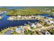 Scenic aerial shot of a waterfront community with lush greenery, deep water canals and boating docks at 4178 Rose Arbor Cir, Port Charlotte, FL 33948
