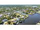 Stunning aerial view of canal homes nestled among mature trees and waterfront beauty at 4178 Rose Arbor Cir, Port Charlotte, FL 33948
