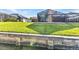 Backyard view of the waterfront property featuring a screened-in patio at 4178 Rose Arbor Cir, Port Charlotte, FL 33948