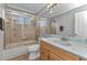 Standard bathroom has a tiled shower and wood vanity with a light-colored countertop at 4178 Rose Arbor Cir, Port Charlotte, FL 33948