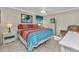 Bright bedroom features vibrant bedding, wicker furniture, and ceiling fan at 4178 Rose Arbor Cir, Port Charlotte, FL 33948