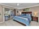 Charming bedroom has tranquil blue bedding and a sliding door to the outside area at 4178 Rose Arbor Cir, Port Charlotte, FL 33948