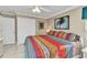Cozy bedroom with colorful bedding, white trim, and closet at 4178 Rose Arbor Cir, Port Charlotte, FL 33948