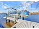 Waterfront property features a covered boat lift, dock, and easy access to the open water at 4178 Rose Arbor Cir, Port Charlotte, FL 33948