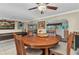 Dining area with wood table and chairs, with the living room visible in the background at 4178 Rose Arbor Cir, Port Charlotte, FL 33948