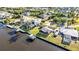Waterfront property featuring lush lawn, boat dock, canal access and screened-in pool area in a serene neighborhood at 4178 Rose Arbor Cir, Port Charlotte, FL 33948