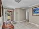 Welcoming foyer with neutral tile flooring, crown molding, and natural light through glass front door at 4178 Rose Arbor Cir, Port Charlotte, FL 33948