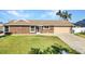 Inviting one-story home with lush green lawn, well-maintained landscaping, and attached garage at 4178 Rose Arbor Cir, Port Charlotte, FL 33948