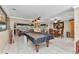 Expansive living area featuring a game room with billiards table and adjacent dining and living spaces at 4178 Rose Arbor Cir, Port Charlotte, FL 33948