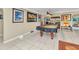 Spacious game room with pool table, neutral tile flooring, and adjacent sitting and dining areas at 4178 Rose Arbor Cir, Port Charlotte, FL 33948